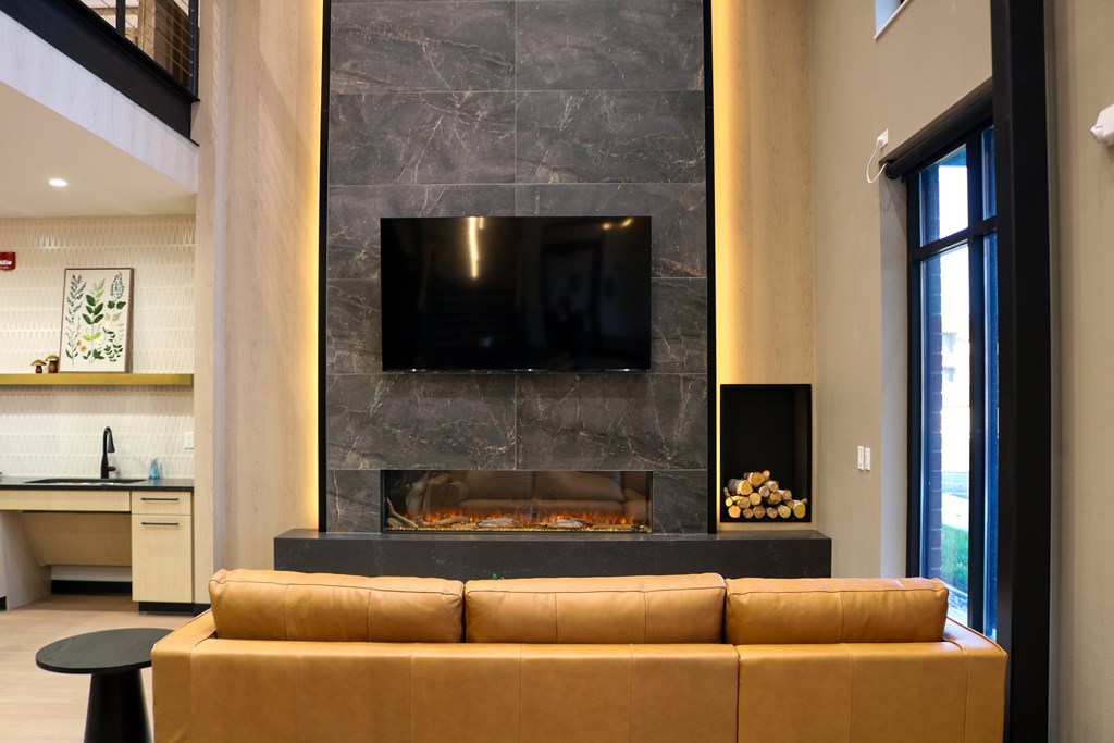 A modern living room with a fireplace and a flat screen TV.