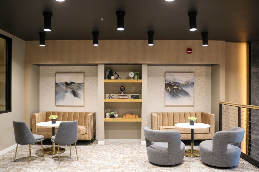 A modern waiting area with grey chairs and a beige sofa.
