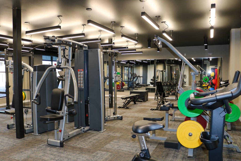 A gym with a variety of equipment including a leg press machine.