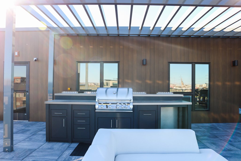 A modern kitchen with a white sofa in front of it.