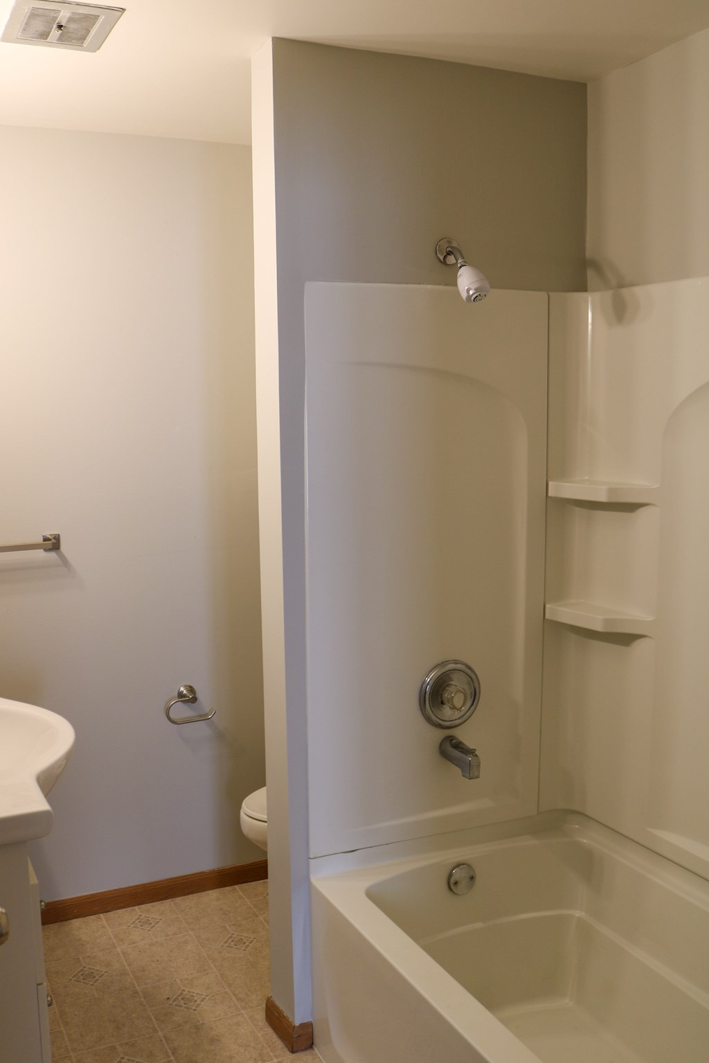 A white bathroom with a sink, toilet, and bathtub.