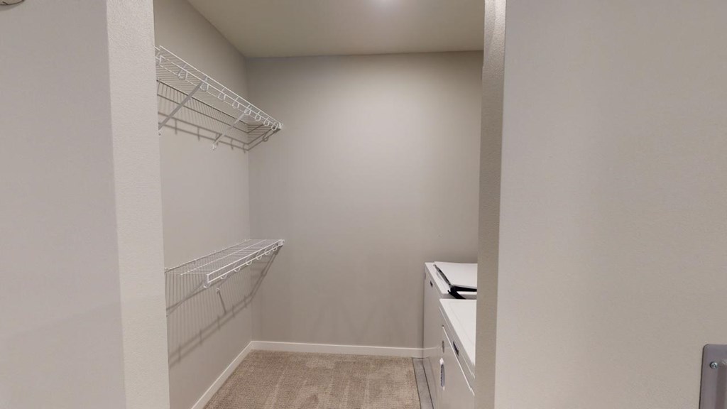 a walk in closet in a home with white walls and shelvesat Northern Lights a Lifestyle-Driven Community, West Fargo, 58078
