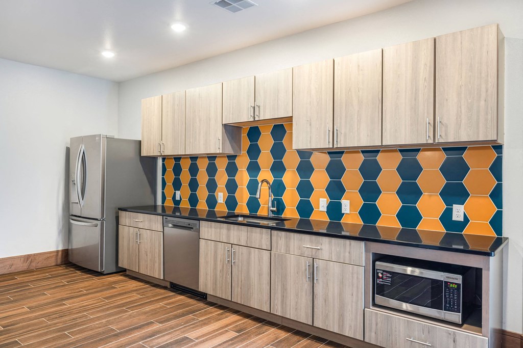 a kitchen with wooden cabinets and a stainless steel refrigeratorat Northern Lights a Lifestyle-Driven Community, West Fargo, ND, 58078