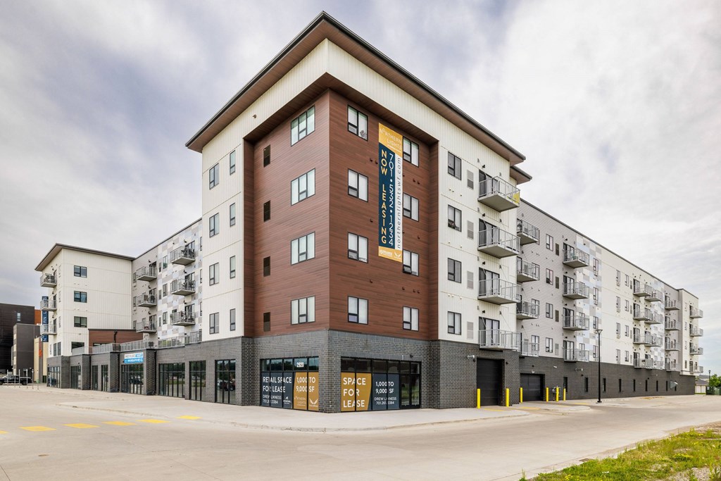 a large apartment building with a street in front of itat Northern Lights a Lifestyle-Driven Community, West Fargo, ND