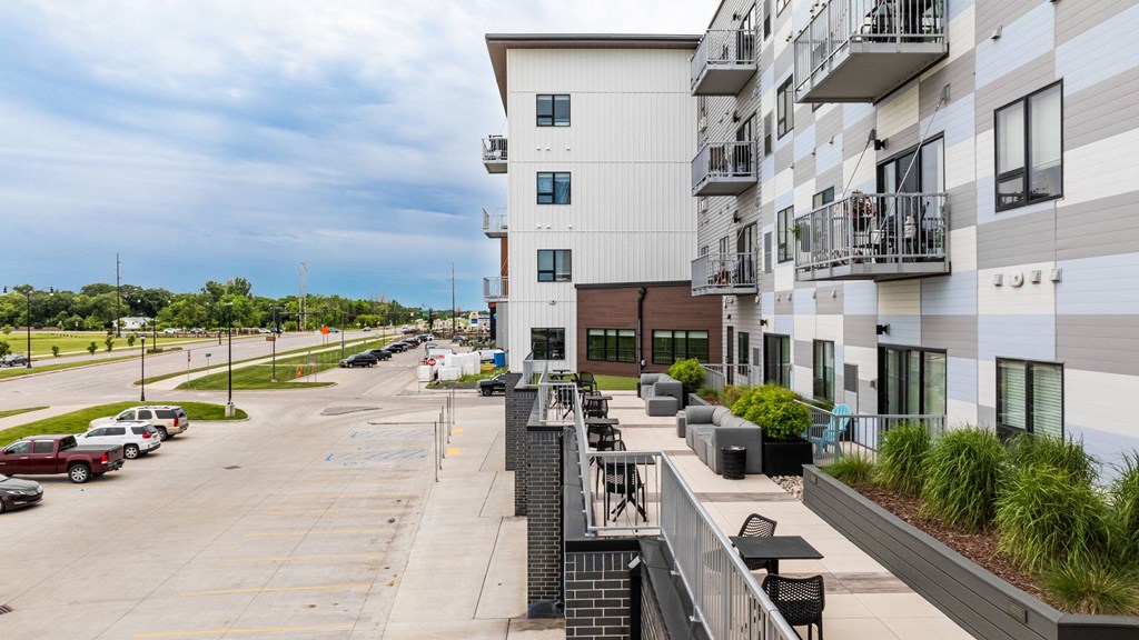 a view of the street from a balcony of a large white buildingat Northern Lights a Lifestyle-Driven Community, West Fargo, 58078