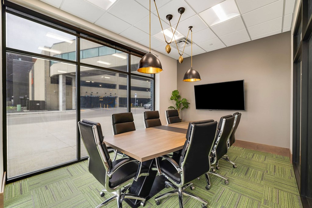 a conference room with a table and chairs and a tvat Northern Lights a Lifestyle-Driven Community, West Fargo, 58078