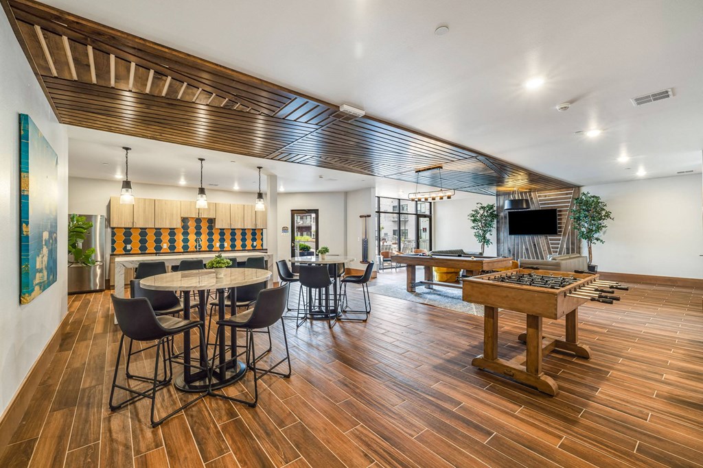 a game room with a pool table and a barat Northern Lights a Lifestyle-Driven Community, West Fargo, North Dakota