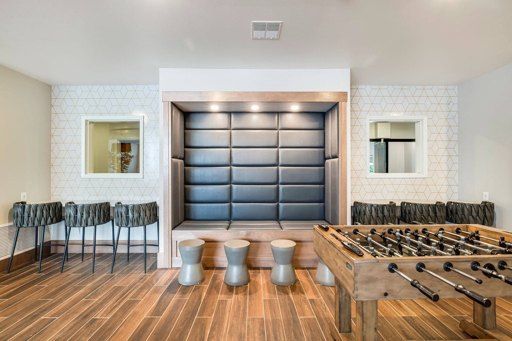 a game room with a foosball table and chairsat Northern Lights a Lifestyle-Driven Community, West Fargo, ND, 58078