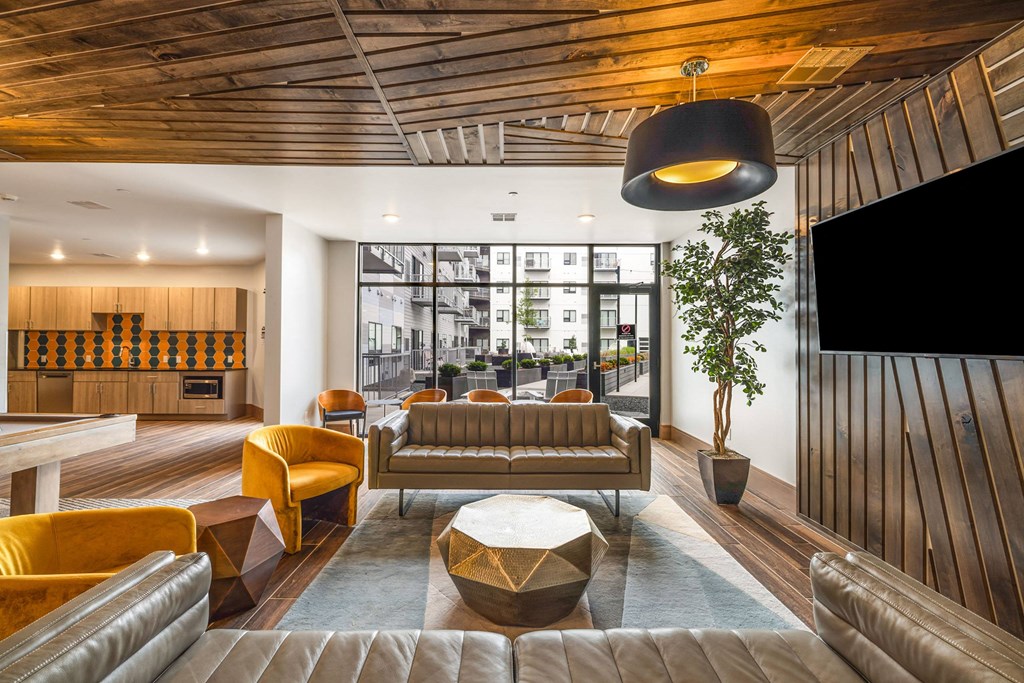 a lounge area with couches and chairs and a televisionat Northern Lights a Lifestyle-Driven Community, West Fargo, 58078