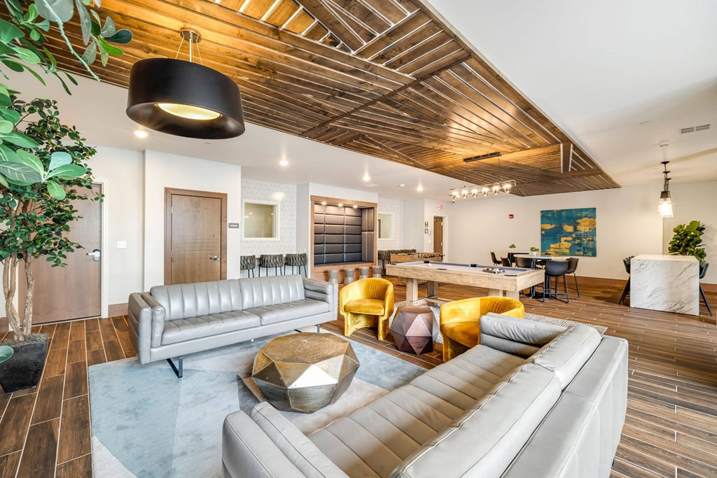 a living room with couches and chairs and a tableat Northern Lights a Lifestyle-Driven Community, West Fargo, 58078