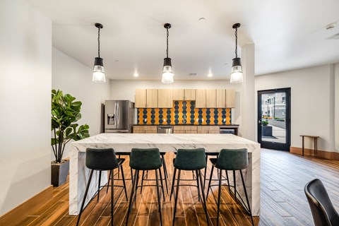 a kitchen with a large island and four chairs