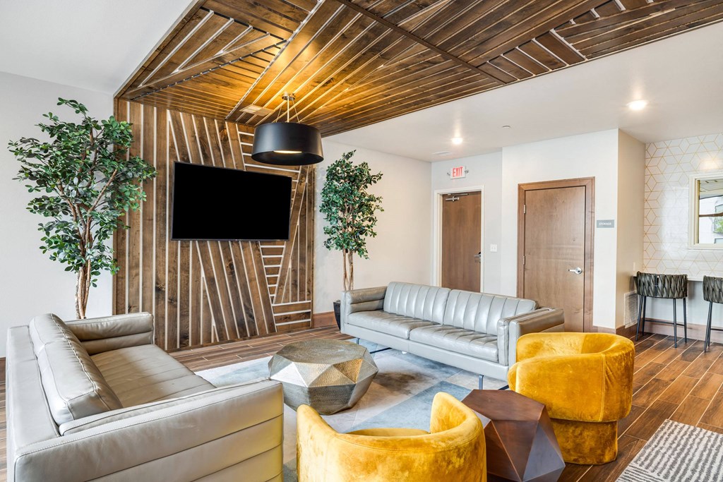 a living room with couches and chairs and a tvat Northern Lights a Lifestyle-Driven Community, West Fargo, ND