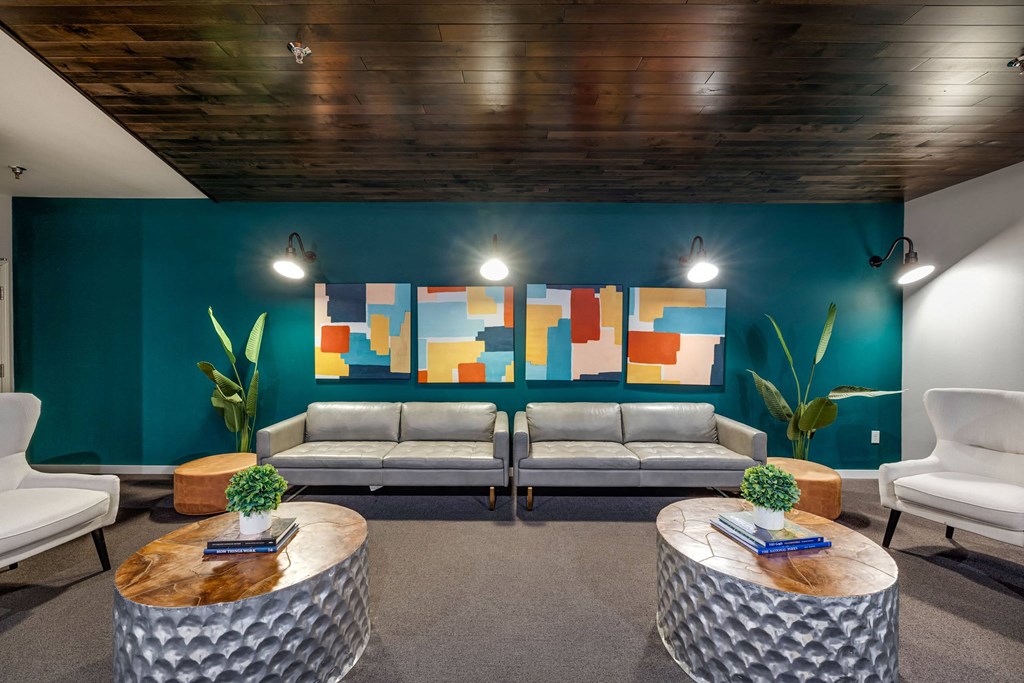 a lobby with couches and tables and a colorful wallat Northern Lights a Lifestyle-Driven Community, West Fargo, 58078
