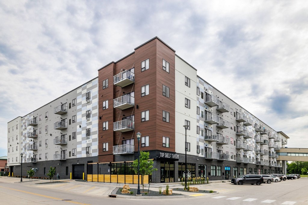 a large apartment building on the corner of a city street at Northern Lights a Lifestyle-Driven Community, West Fargo, ND