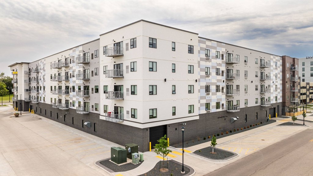 a large white apartment building with a street in front of itat Northern Lights a Lifestyle-Driven Community, West Fargo, North Dakota