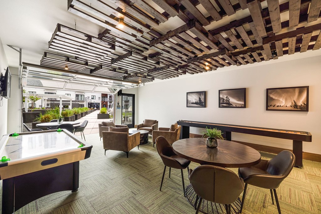 a room with tables and chairs and a pool tableat Northern Lights a Lifestyle-Driven Community, West Fargo, ND