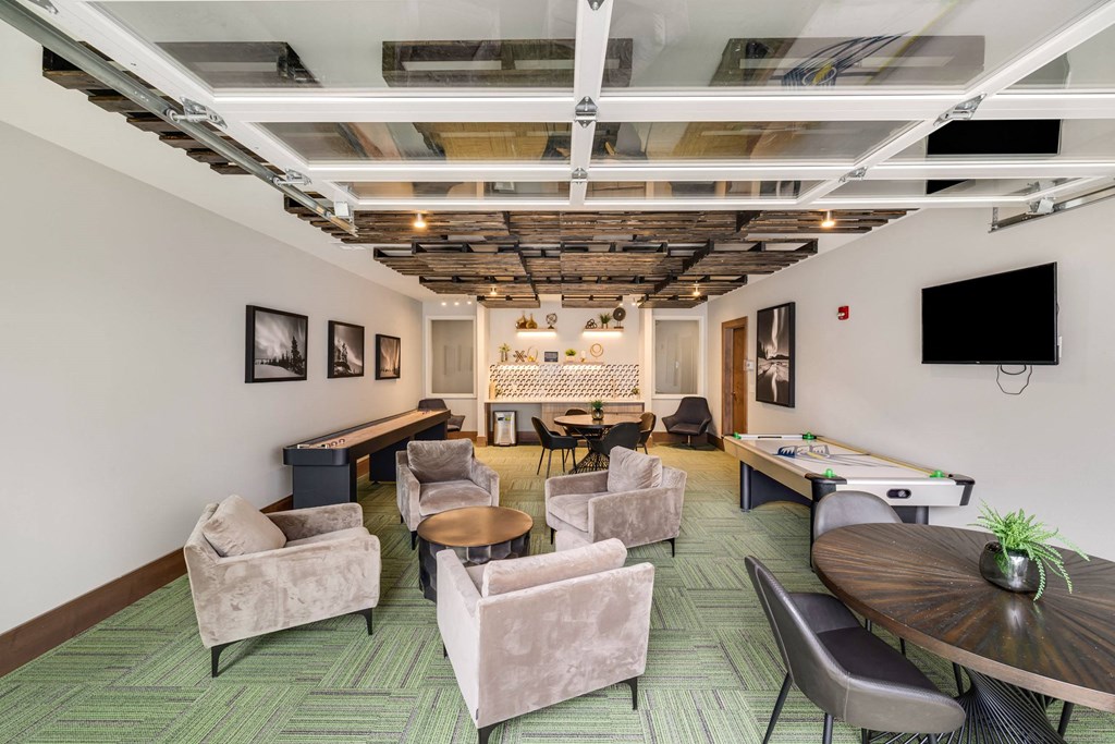 a living room with chairs tables and a pool tableat Northern Lights a Lifestyle-Driven Community, West Fargo, ND