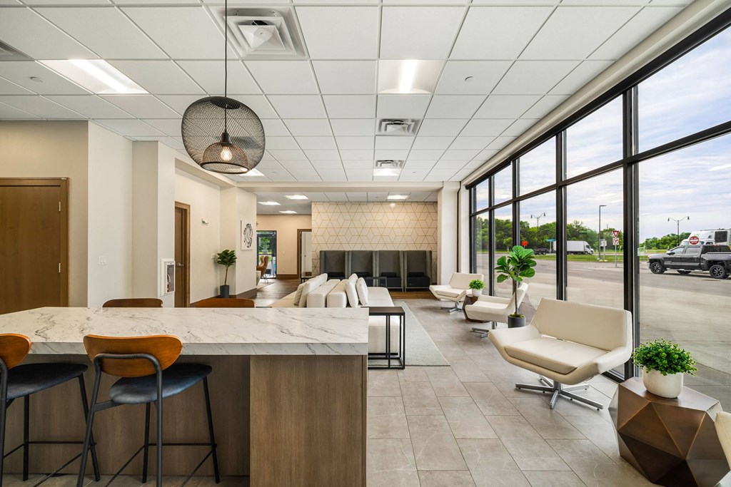 a lobby with a table and chairs and a fireplaceat Northern Lights a Lifestyle-Driven Community, West Fargo, North Dakota