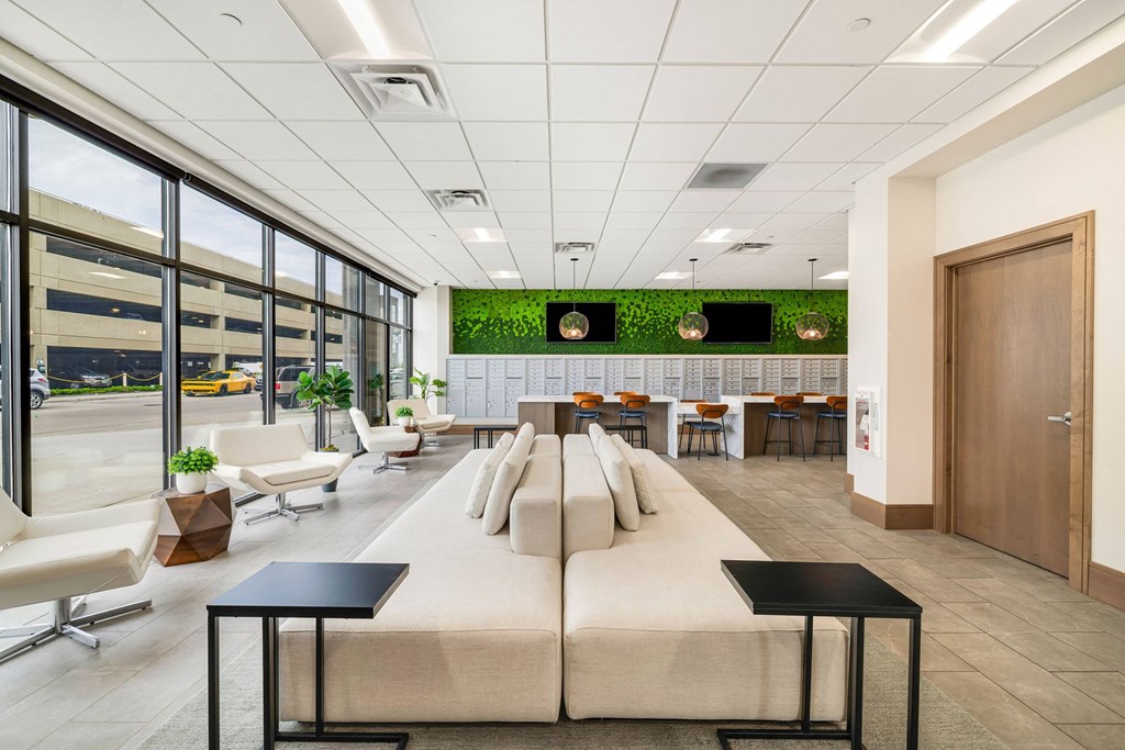 a large lobby with couches and chairs and a table with chairsat Northern Lights a Lifestyle-Driven Community, West Fargo, North Dakota