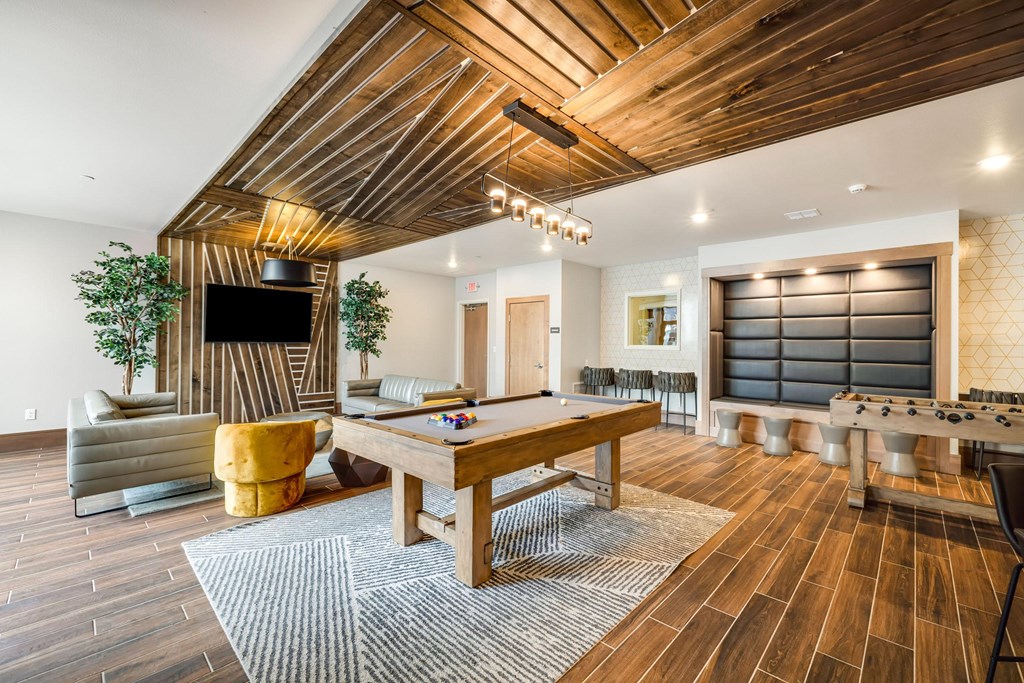 a game room with a pool table and a television a game room with a pool table and a televisionat Northern Lights a Lifestyle-Driven Community, West Fargo, ND