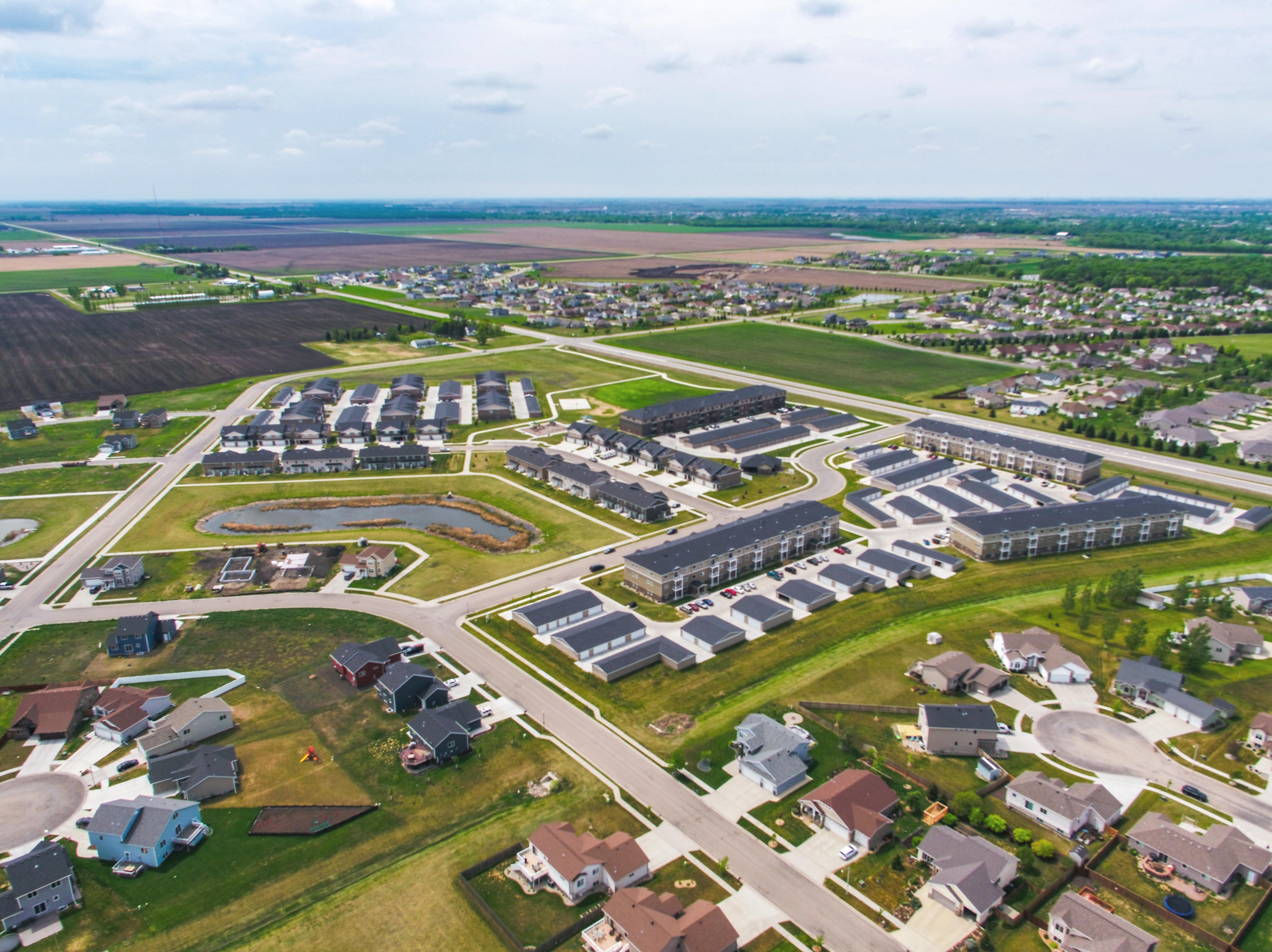 A bird's eye view of a residential area with houses and apartment buildings.