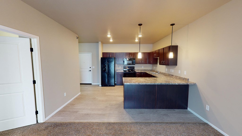 A kitchen area with a countertop and cabinets.