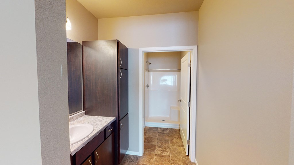 A bathroom with a sink and a mirror.