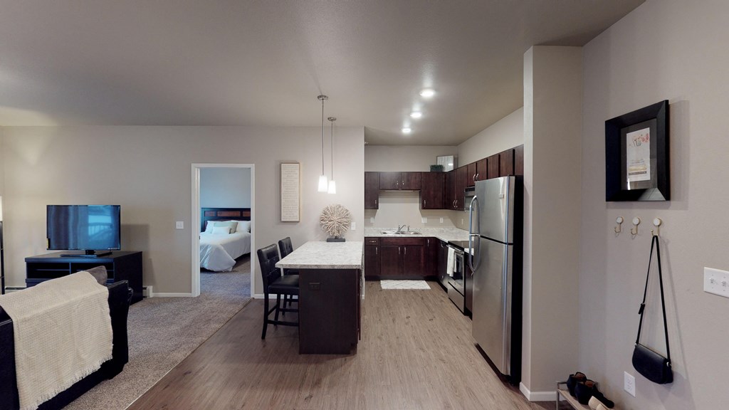 A modern kitchen with a dining table and chairs.