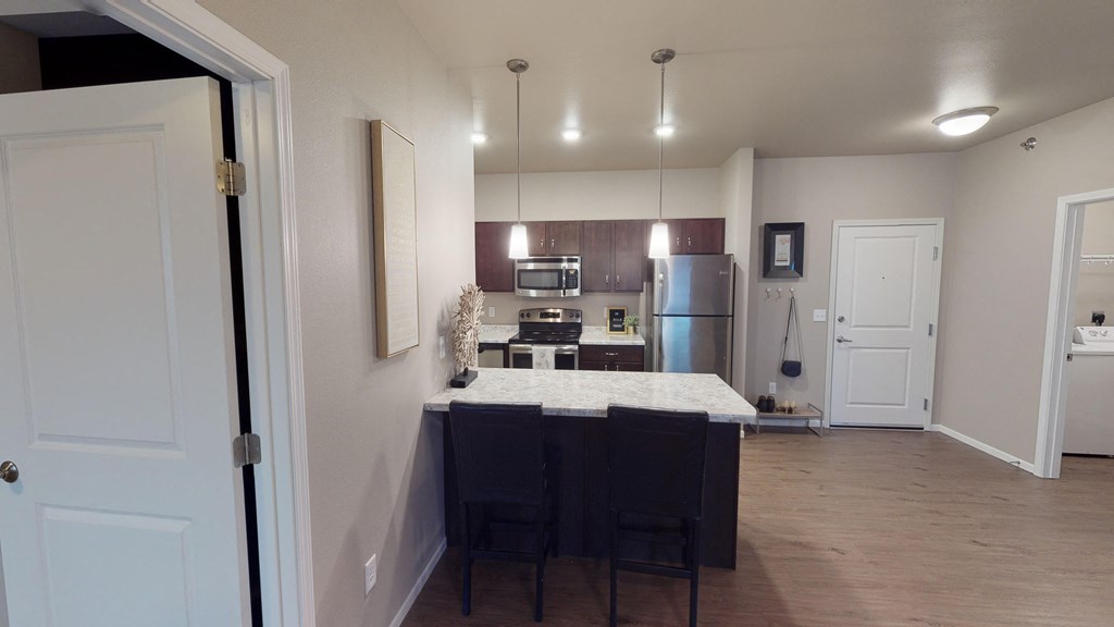 A kitchen with a table and chairs in the middle of the room.