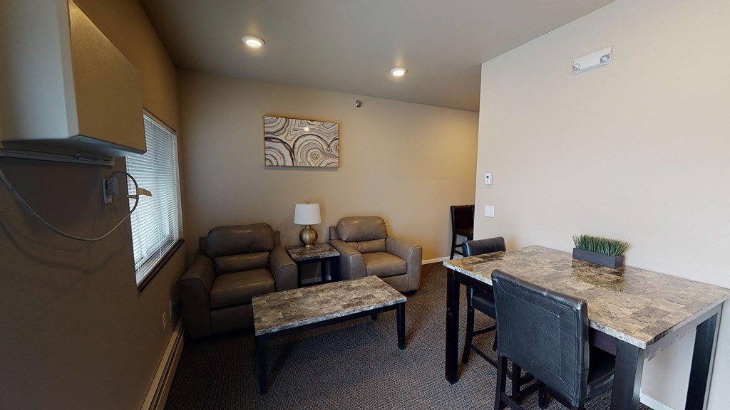 A living room with a couch, chair, and table.