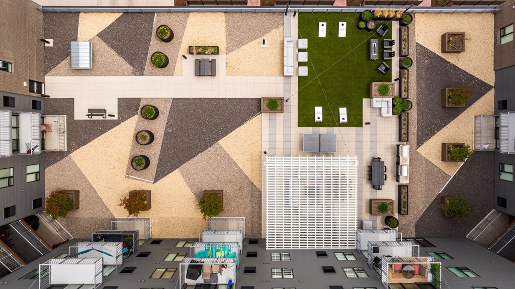 an aerial view of a building with a courtyard and grass at EagleRidge Plaza Residences, Fargo, ND