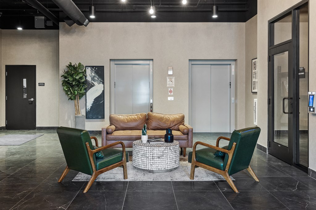 a lobby with a couch and two chairs at EagleRidge Plaza Residences, Fargo, North Dakota