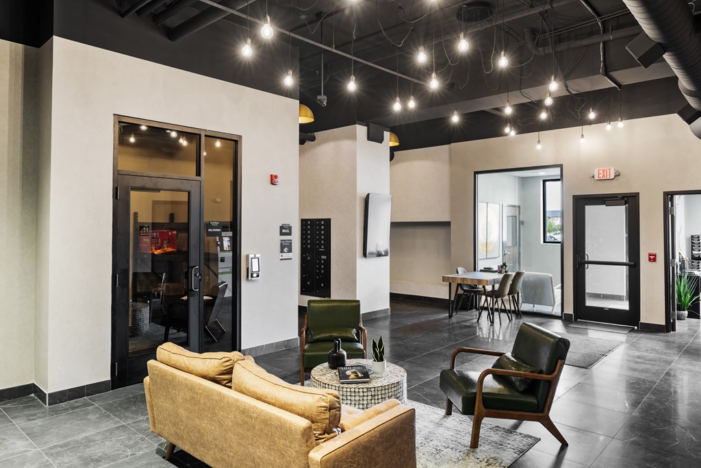 a living room with a couch and chairs and a dining room at EagleRidge Plaza Residences, Fargo