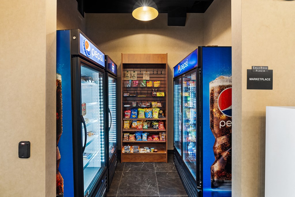 a hallway with two refrigerators and vending machines in a store at EagleRidge Plaza Residences, Fargo, 58104