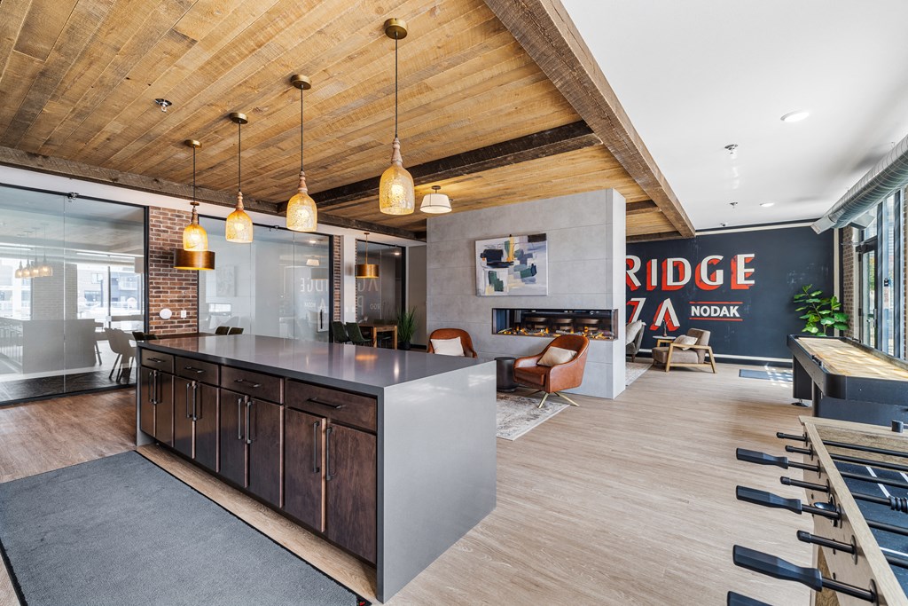 a kitchen with a large island in the middle of a room with a living room at EagleRidge Plaza Residences, North Dakota, 58104