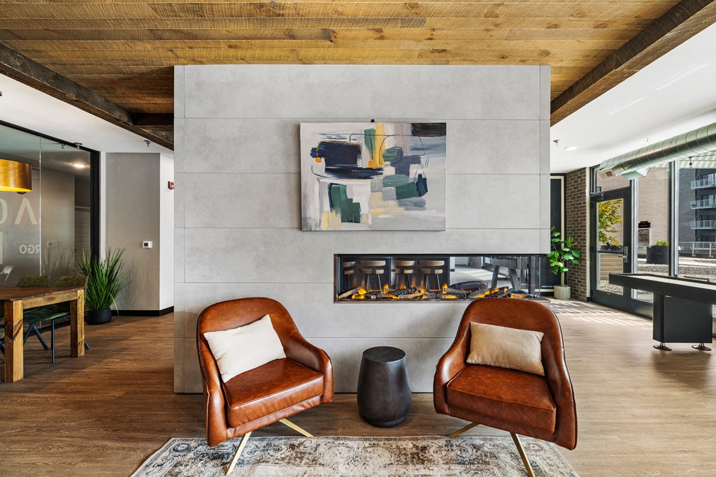 a living room with two chairs and a fireplace at EagleRidge Plaza Residences, Fargo, ND, 58104