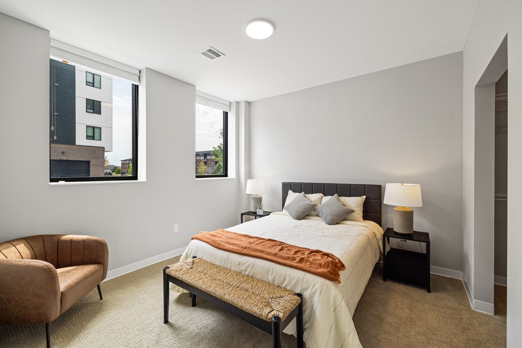 a bedroom with a large bed and two windows at EagleRidge Plaza Residences, North Dakota, 58104