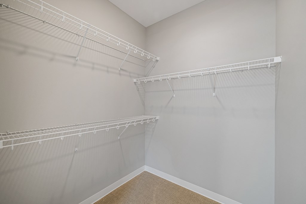 a spacious closet with shelves and hanging racks in an empty room at EagleRidge Plaza Residences, Fargo, ND
