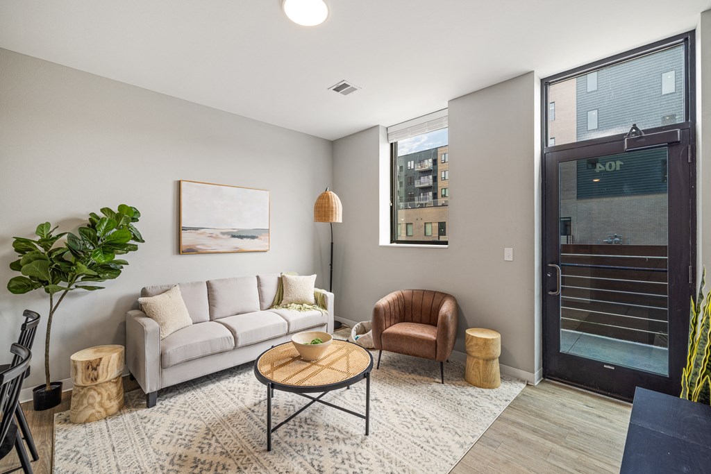 a living room with a white couch and a door to a balcony at EagleRidge Plaza Residences, Fargo, North Dakota