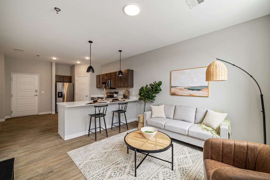a living room with a couch and a kitchen with a bar at EagleRidge Plaza Residences, Fargo, ND, 58104