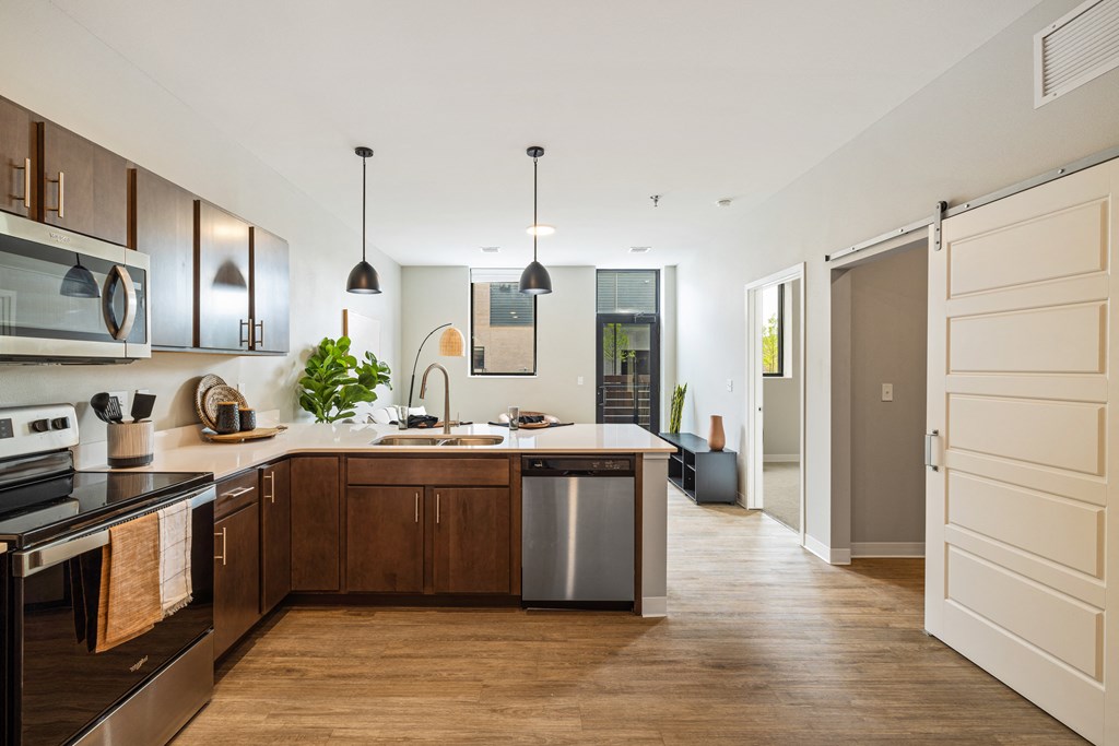 a large kitchen with wooden cabinets and a white counter top at EagleRidge Plaza Residences, Fargo, North Dakota