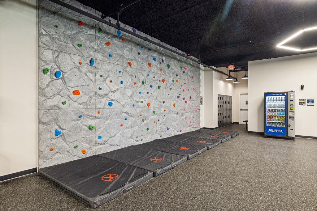 a climbing wall in a room with a vending machine at EagleRidge Plaza Residences, North Dakota