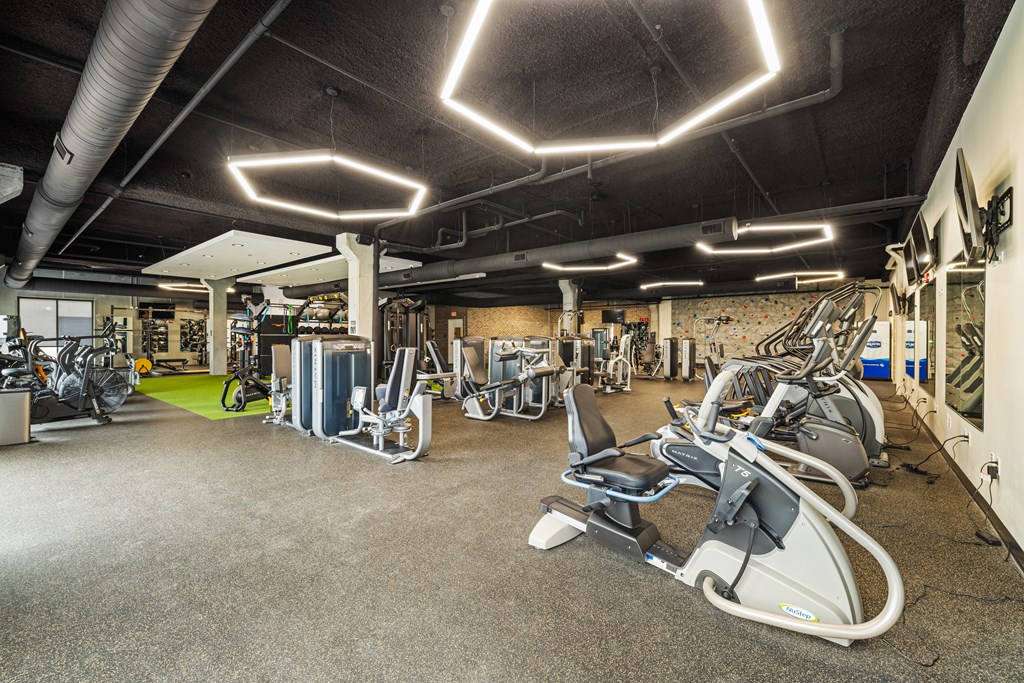 a gym with exercise equipment and lights on the ceiling at EagleRidge Plaza Residences, Fargo