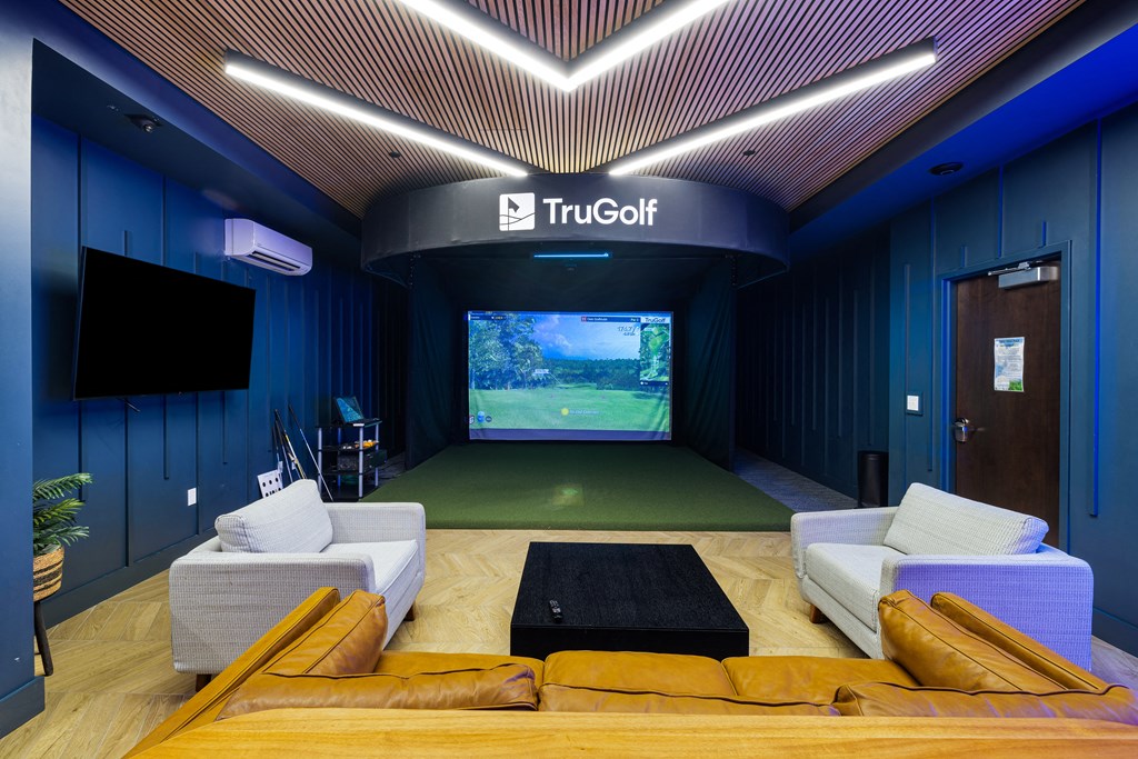 a living room with a large screen tv and couches at EagleRidge Plaza Residences, North Dakota