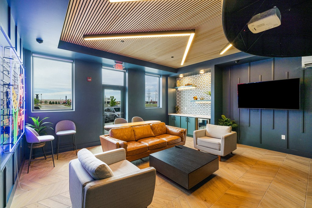 a lobby with couches and chairs and a tv at EagleRidge Plaza Residences, Fargo