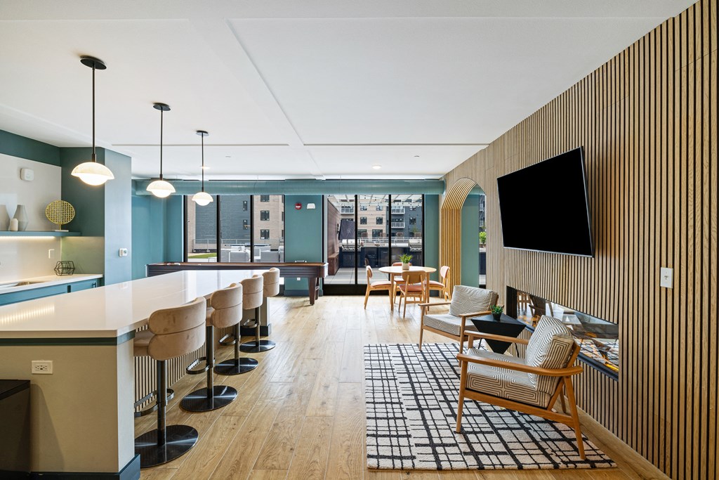 a lobby with a bar and chairs and a television at EagleRidge Plaza Residences, North Dakota, 58104