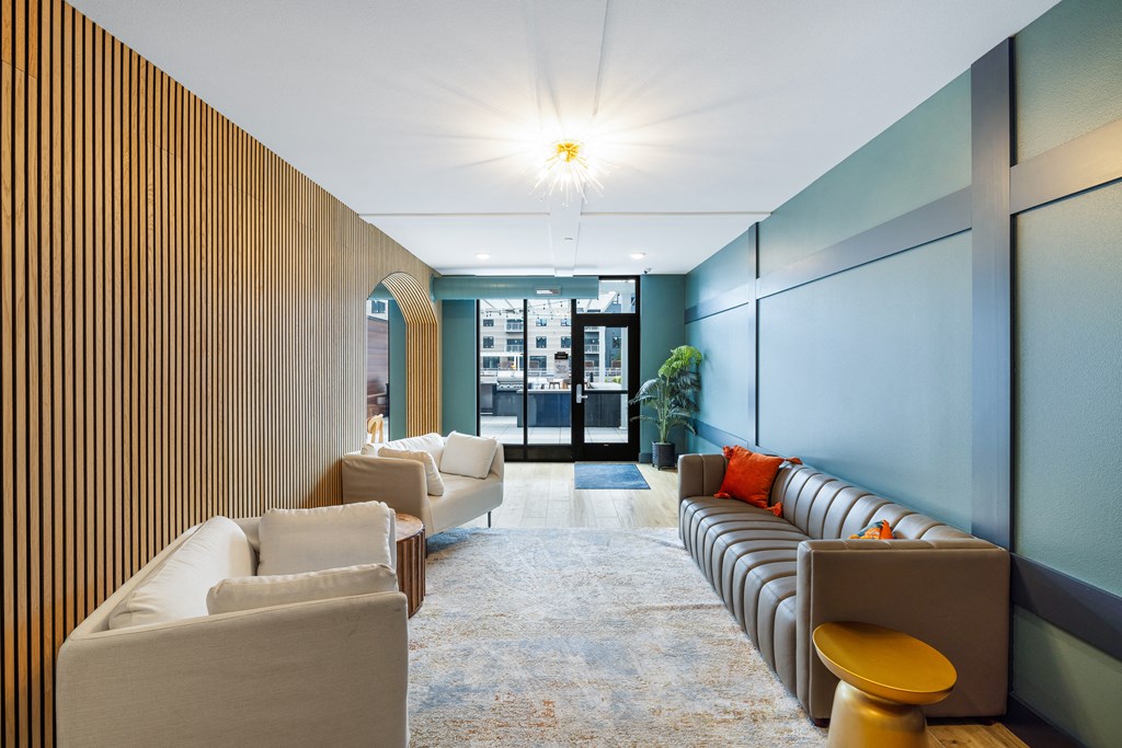 a lobby with couches and chairs and a wall with a door at EagleRidge Plaza Residences, Fargo, ND, 58104