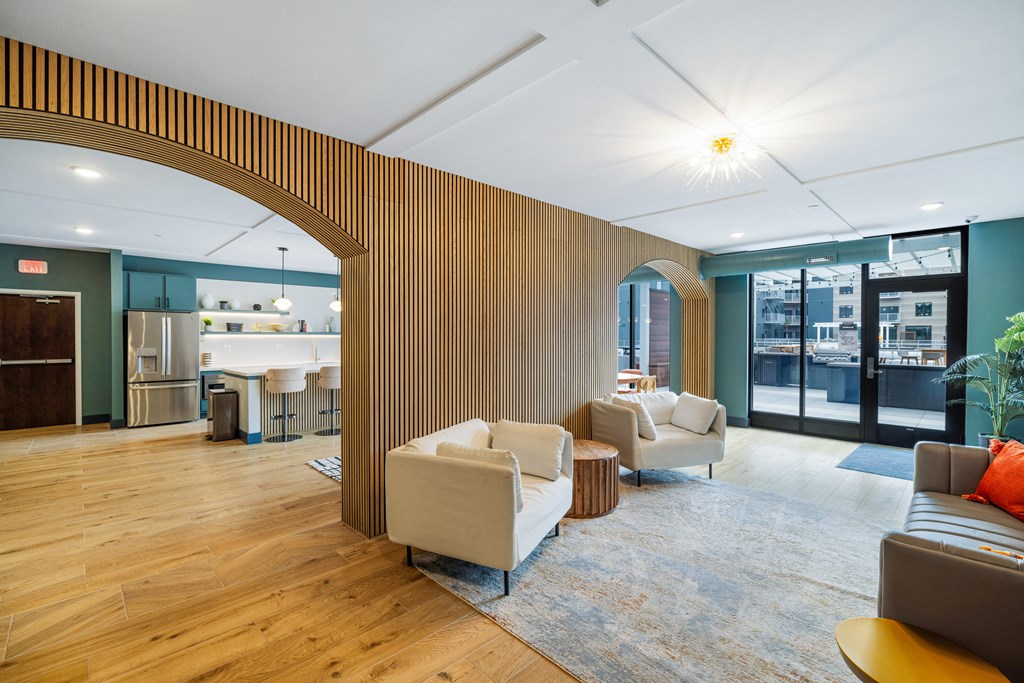a living room with couches and chairs and a kitchen at EagleRidge Plaza Residences, Fargo, 58104