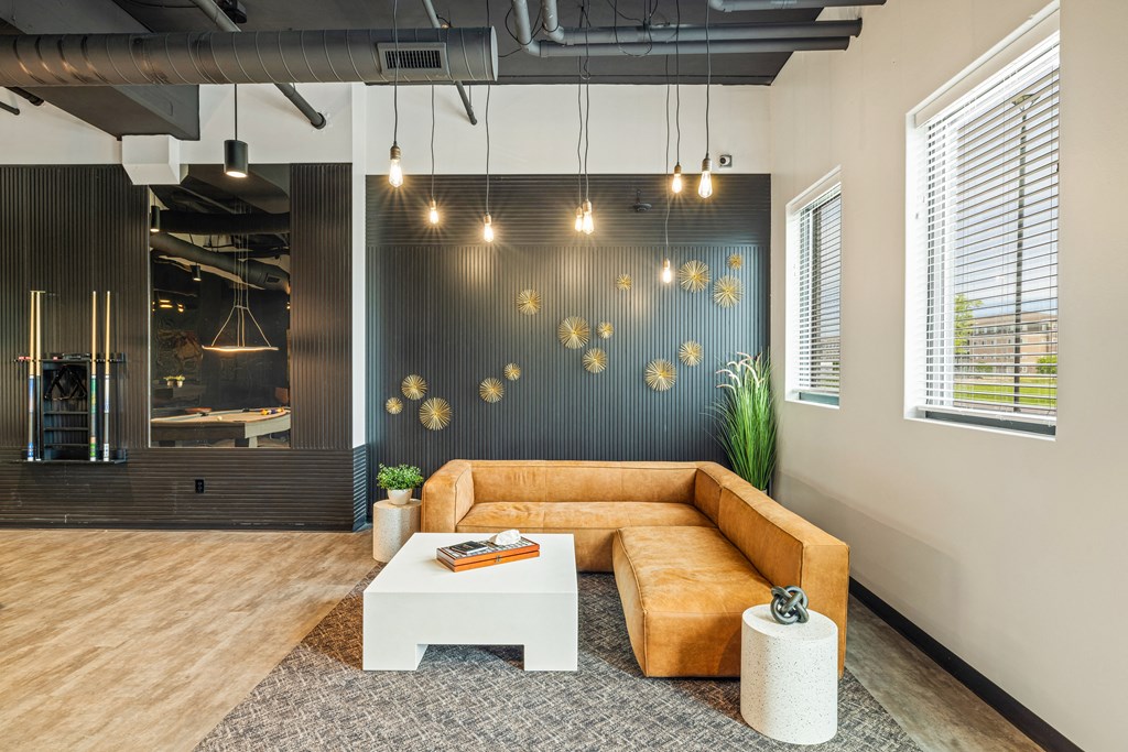 a living room with a brown couch and a white coffee table at EagleRidge Plaza Residences, North Dakota, 58104