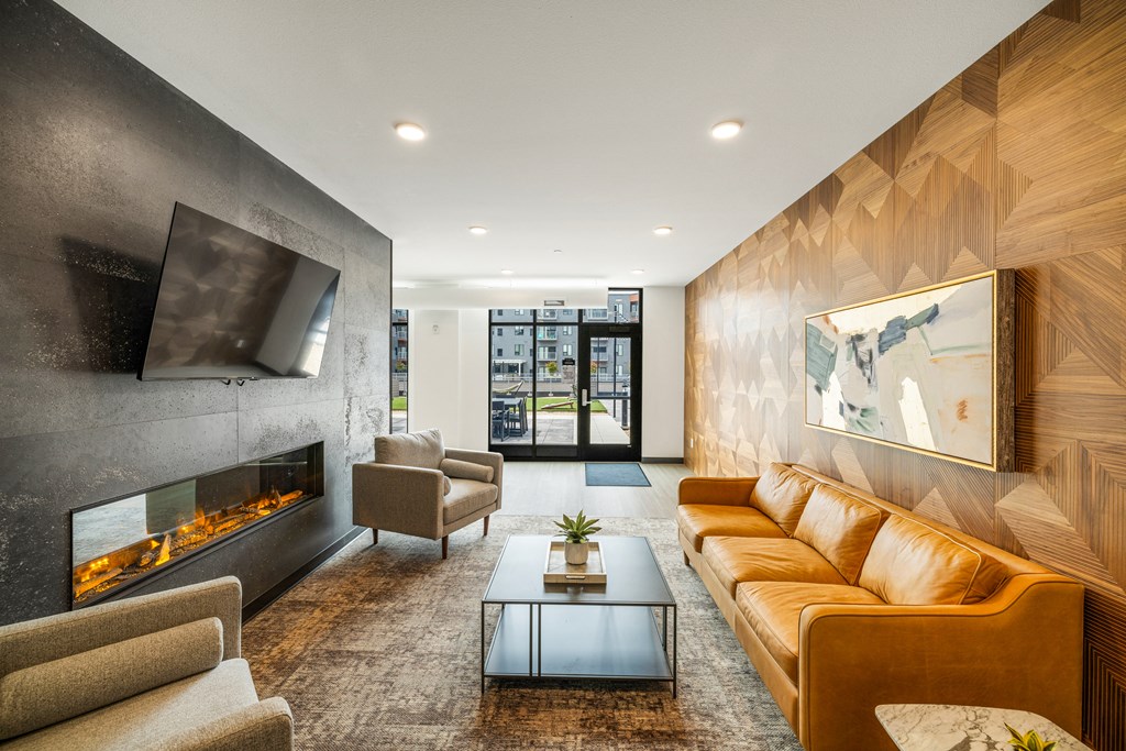 a living room with couches and a coffee table and a fireplace at EagleRidge Plaza Residences, North Dakota, 58104